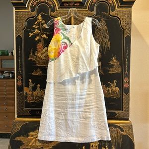 White dress with colorful accent and diagonal ruffle